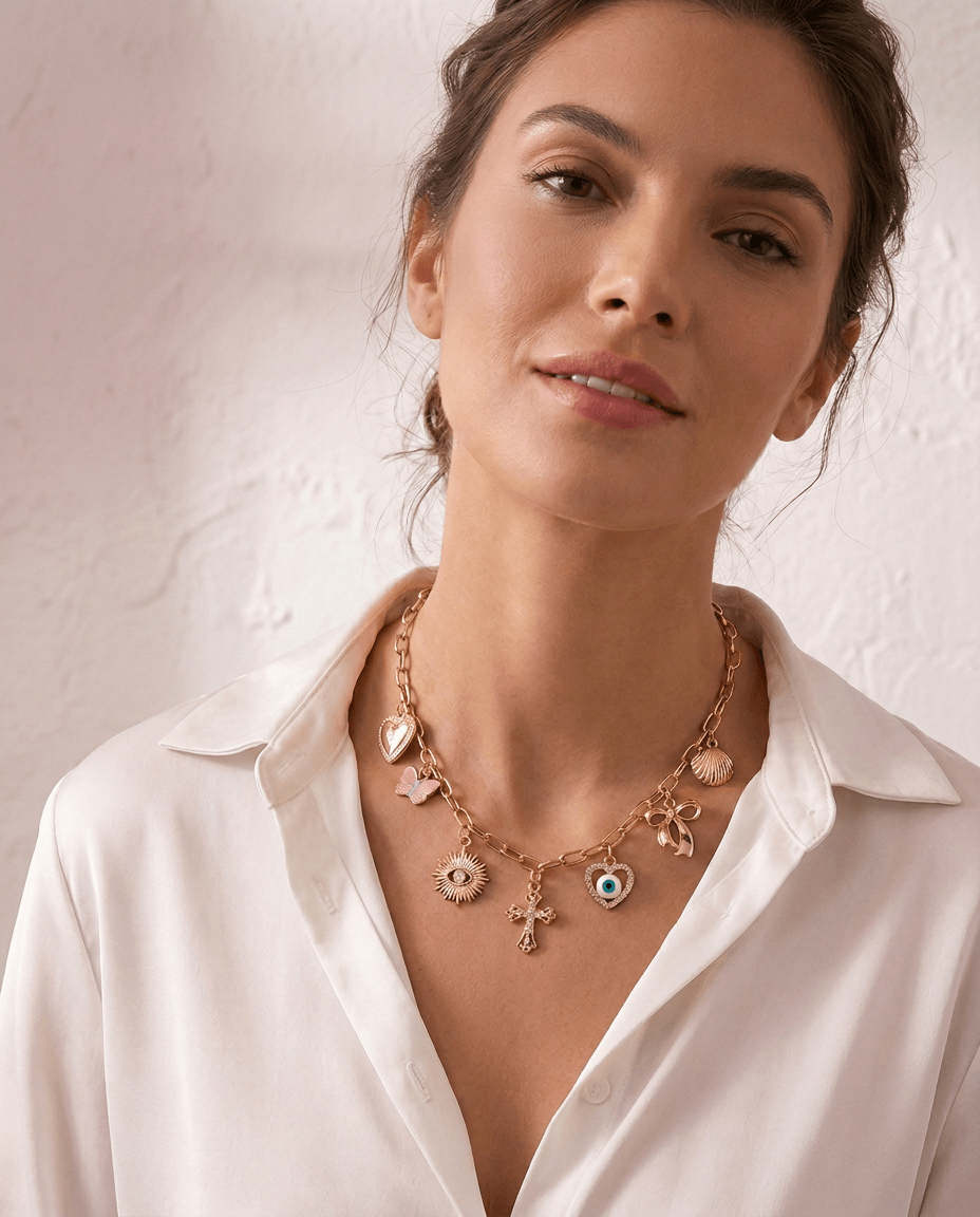 Love & Luck Charm Necklace by Frosted Feminine, layered gold charm necklace styled on a feminine neckline